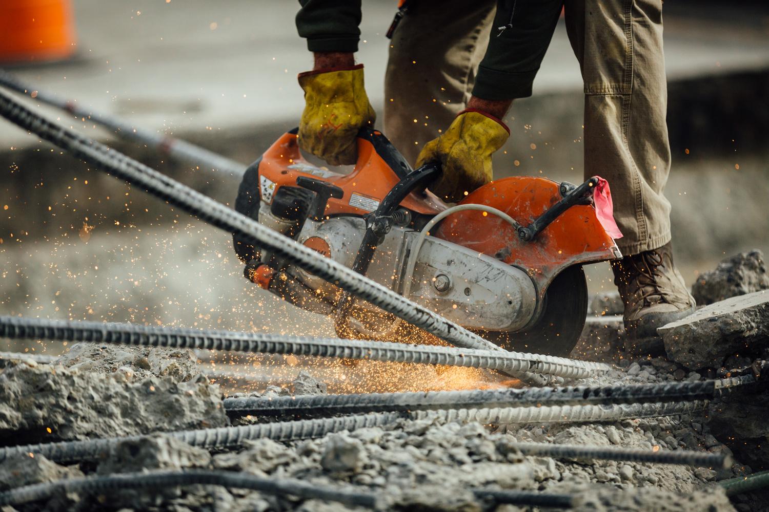 Construction worker cutting rebar