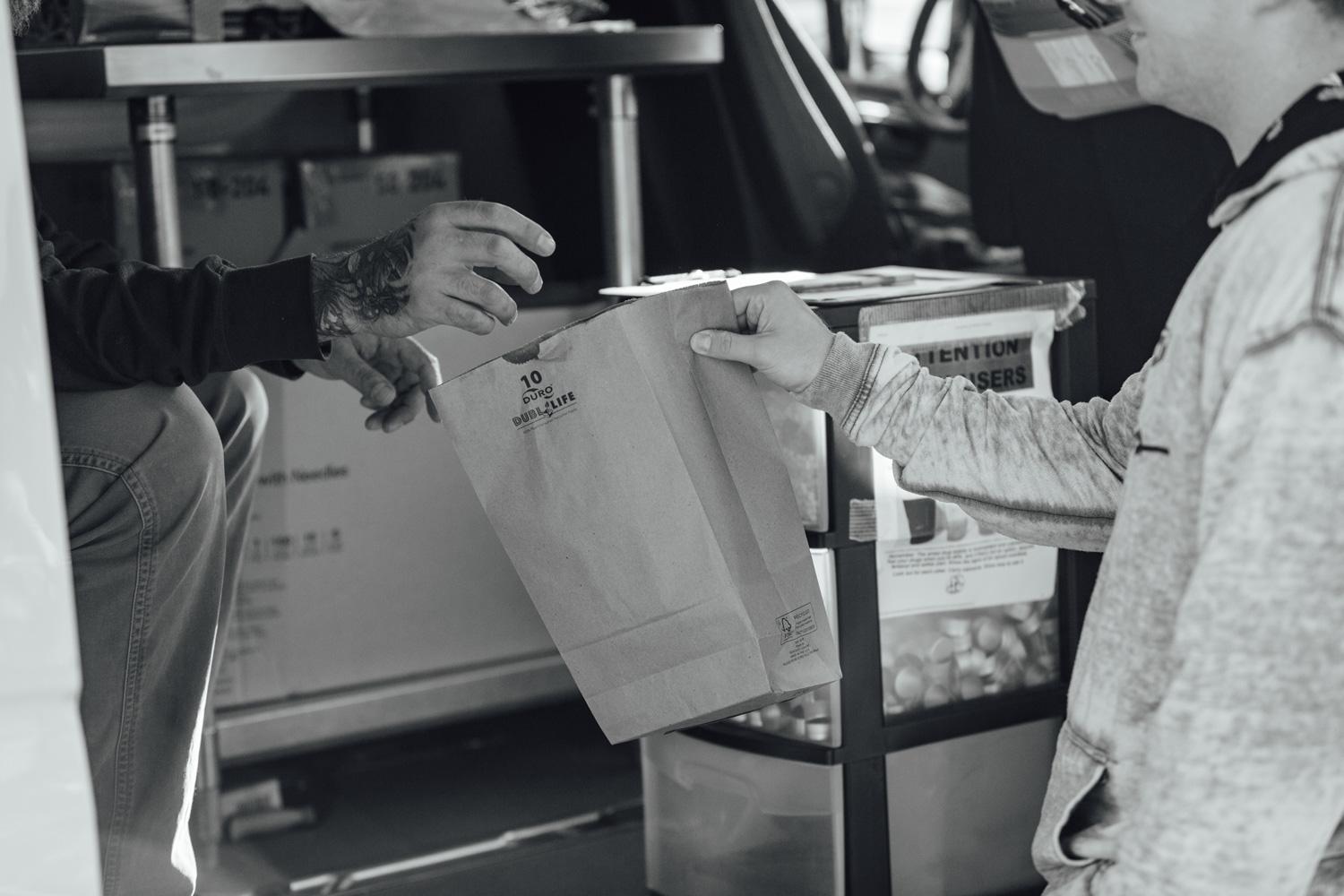 Man taking a bag of new needles