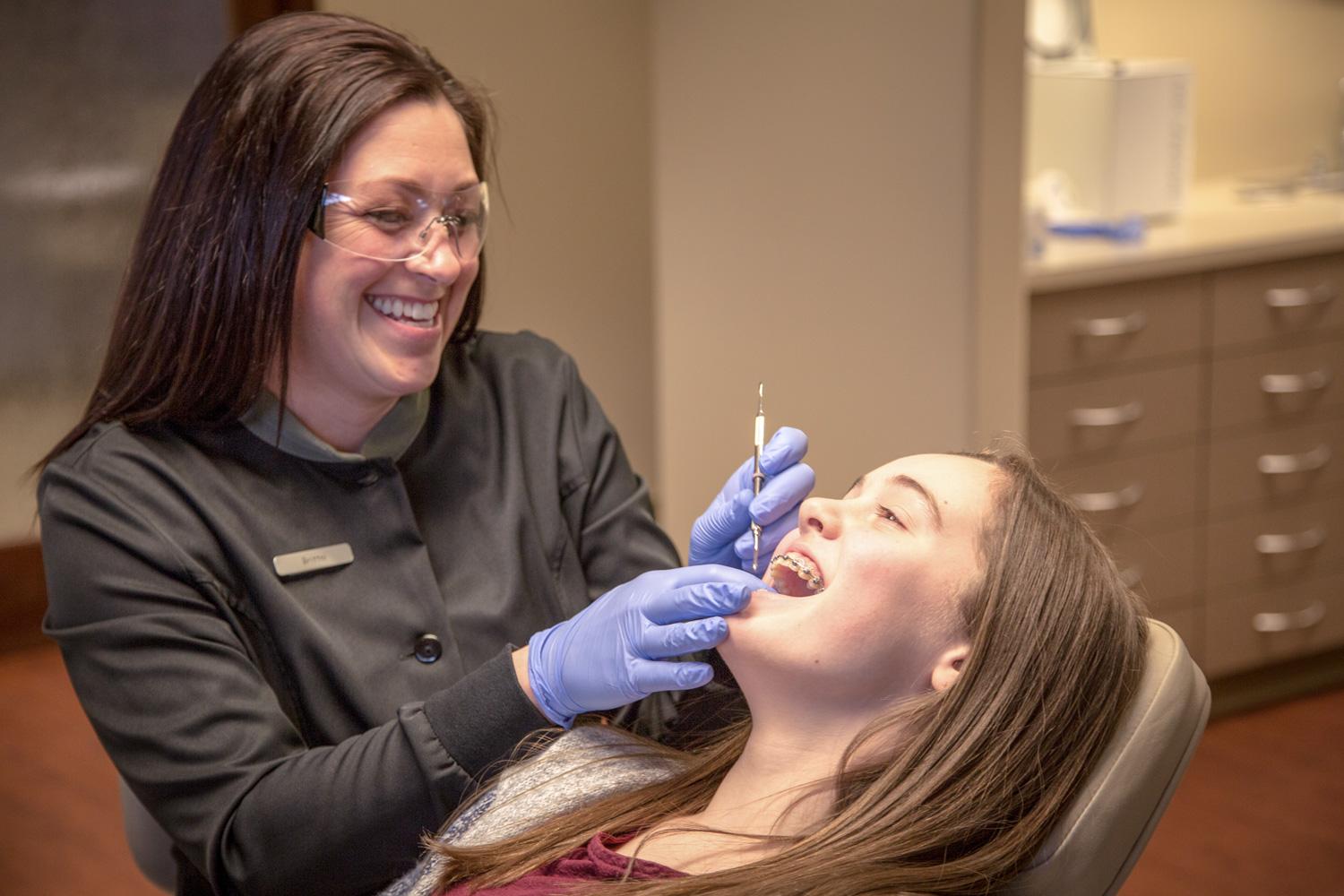 Teenager getting her braces adjusted